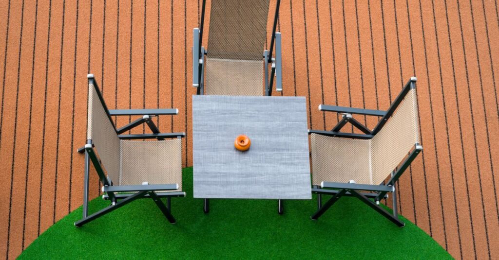 Artificial turf over existing grass: a finished artificial lawn in a backyard